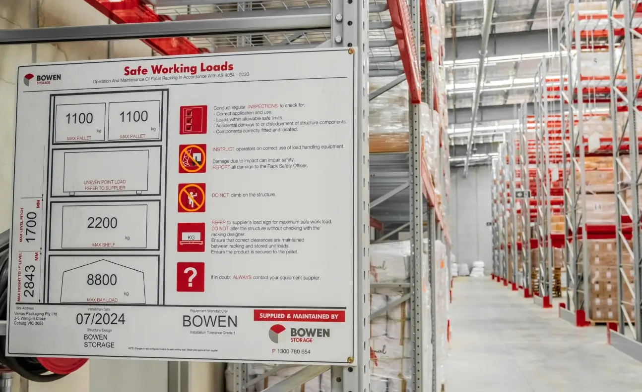 Warehouse pallet racking safe working load signage displayed on storage system upright